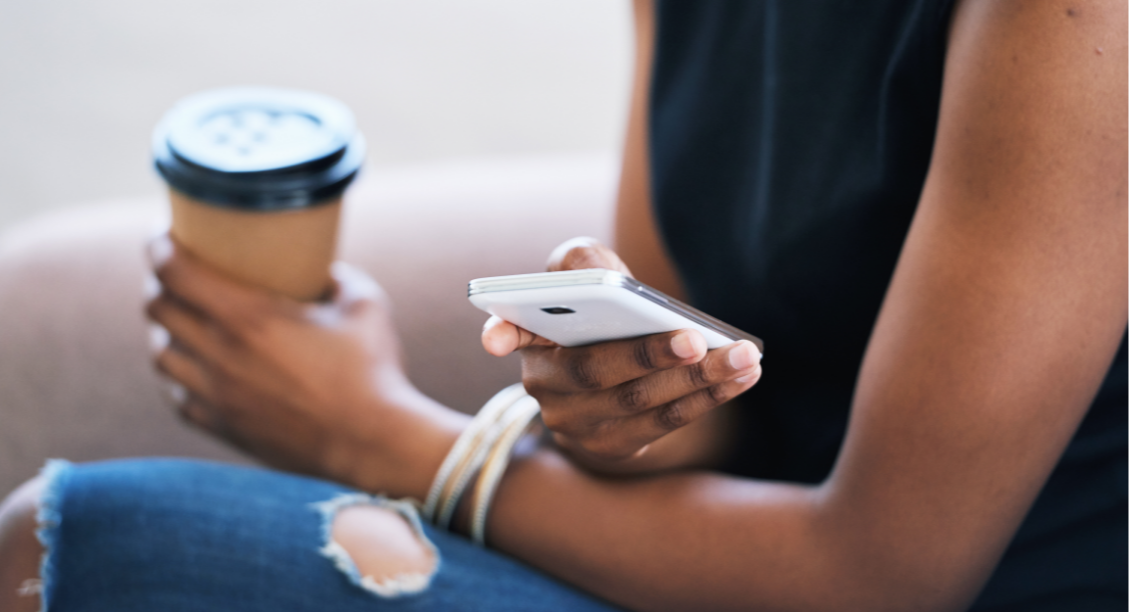 woman-using-smartphone-browsing-messages-social-media-texting-mobile-phone-holding-coffee